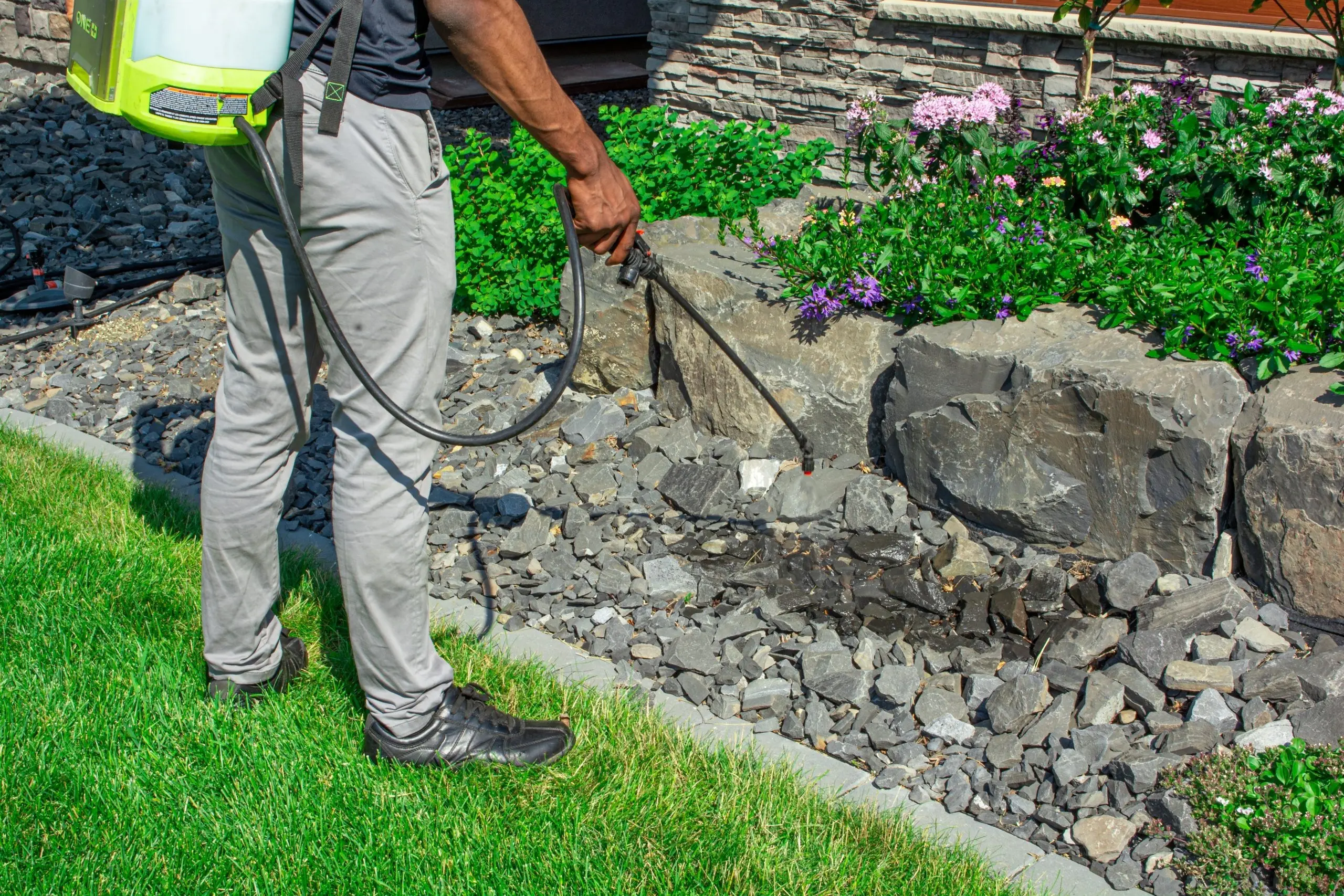 NH Hero spraying landscape weed killer