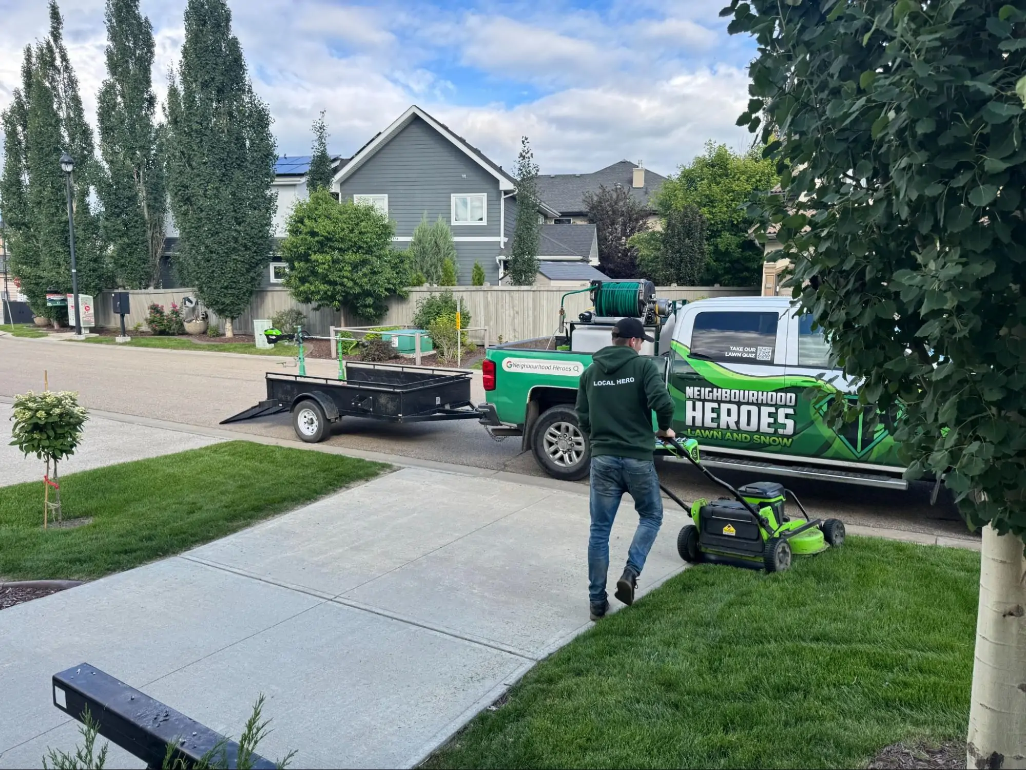a lawn technician performing commercial lawn mowing services
