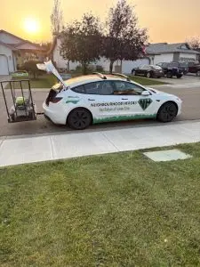 Tesla with mower attached behind